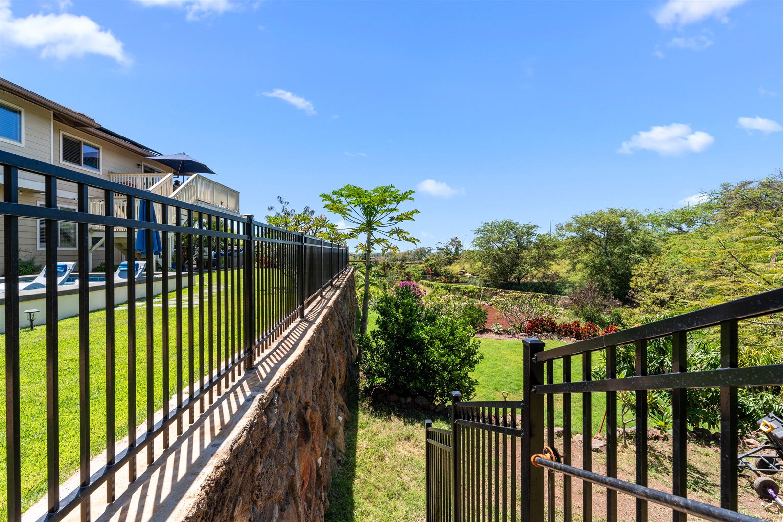 Black aluminum fence and stair railing on a rock wall, Oahu