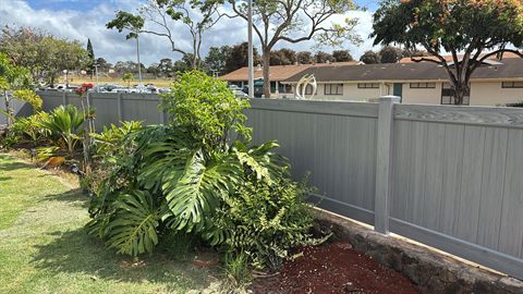 Chai Gray vinyl privacy fence on a lava rock wall, Oahu