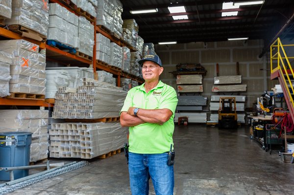 Founder Lindy Risner in the Upright Fencing vinyl material warehouse in Kapolei